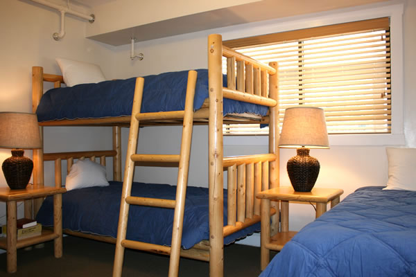 A room with bunk beds and a table.